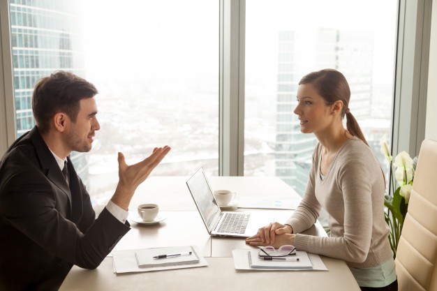 businessman-businesswoman-discussing-work-office-desk